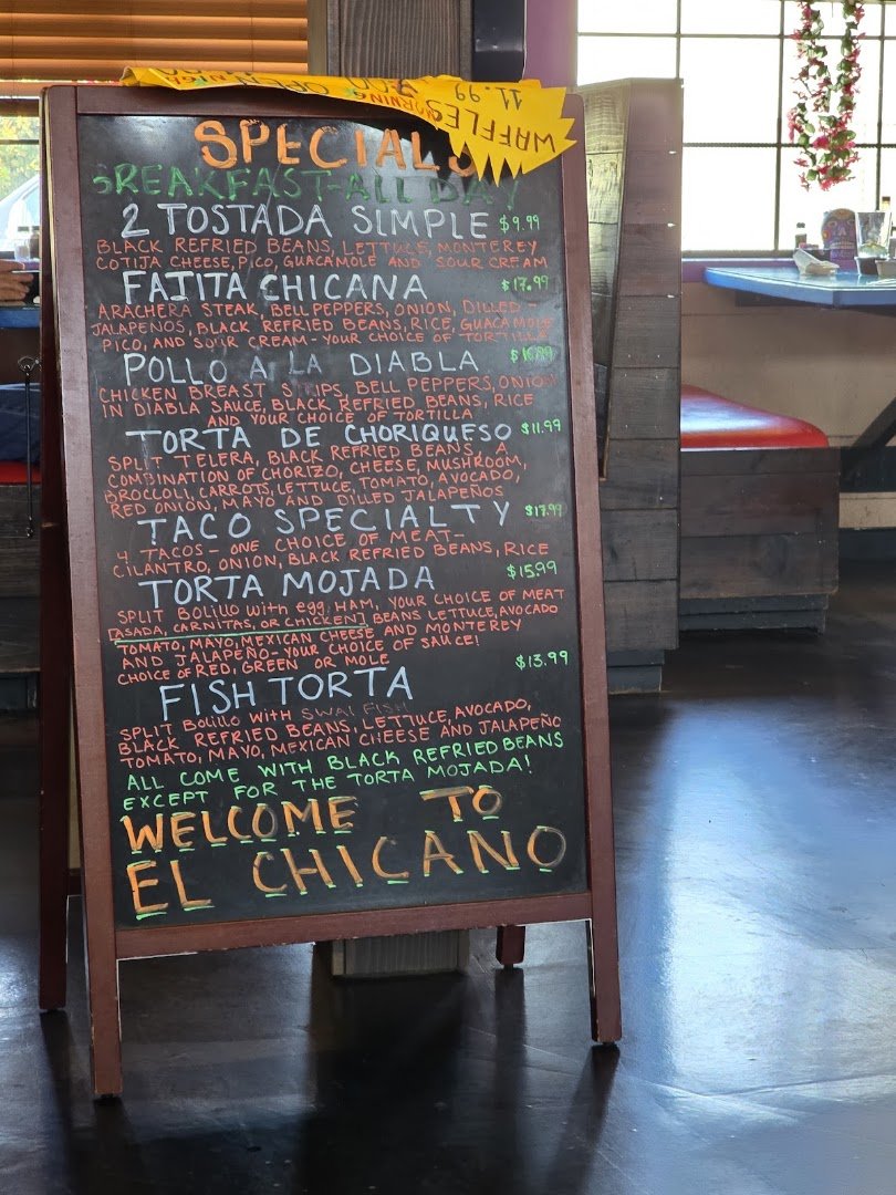 Mexican restaurant interior with seating and warm tones.
