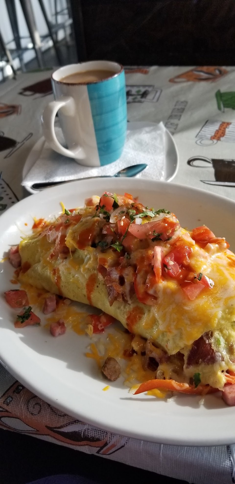Printed menu with omelettes, fajitas, and enchiladas.