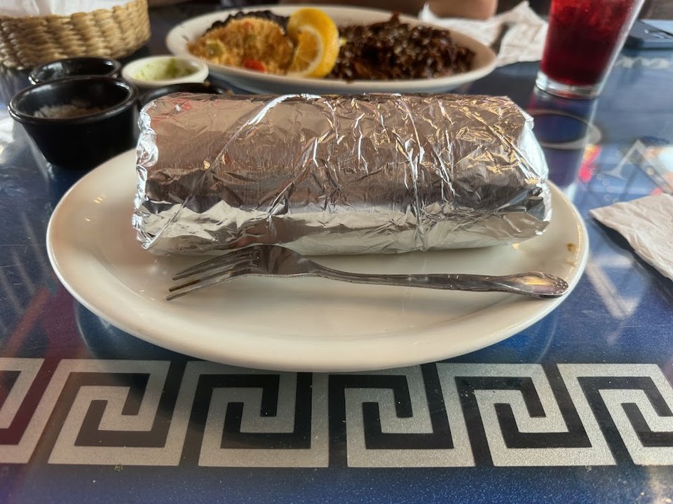 Printed menu with omelettes, fajitas, and enchiladas.