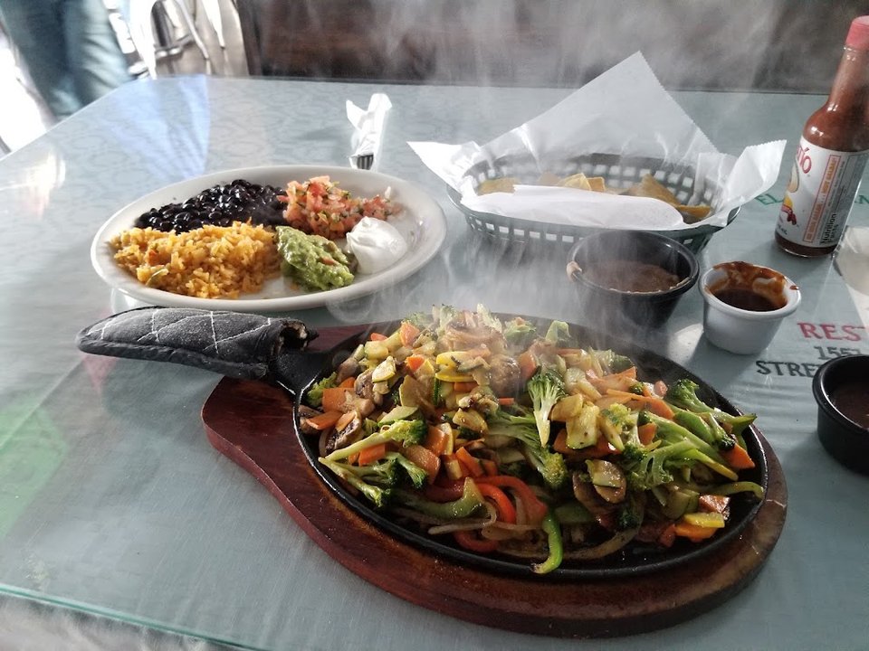Printed menu with omelettes, fajitas, and enchiladas.